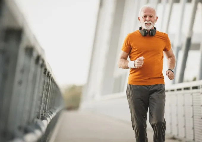 Older adult jogging outdoors as part of an arthritis exercise programme